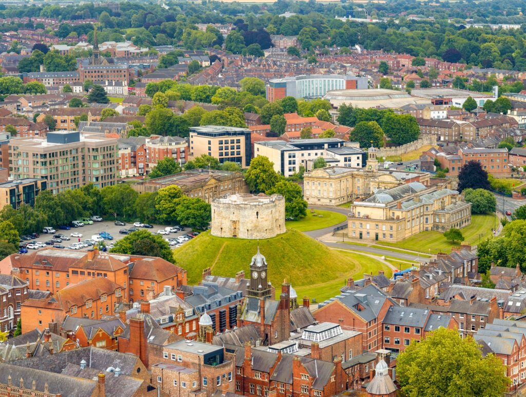 Clifford's Tower, surrounding by other buildings